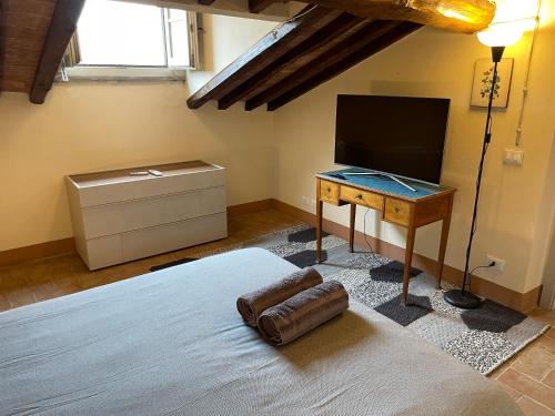 a bedroom with a bed and a desk with a television at 2 King Bed, 2 Full Bathroom Apartment in Umbria - Tuscany in Città della Pieve