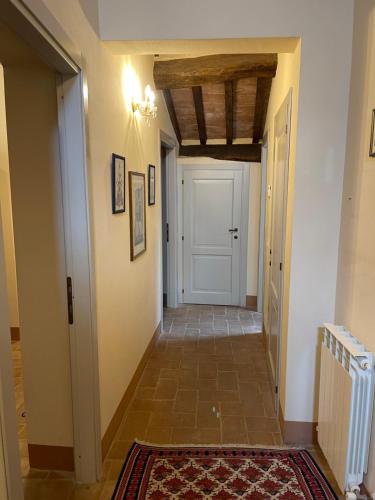 a hallway with a white door and a tile floor at 2 King Bed, 2 Full Bathroom Apartment in Umbria - Tuscany in Città della Pieve