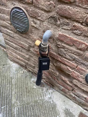 a wall with a microphone on a brick wall at 2 King Bed, 2 Full Bathroom Apartment in Umbria - Tuscany in Città della Pieve