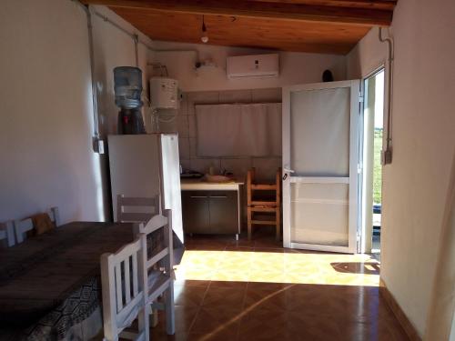 a kitchen with a refrigerator and a table in it at Hospedaje San Mayol 