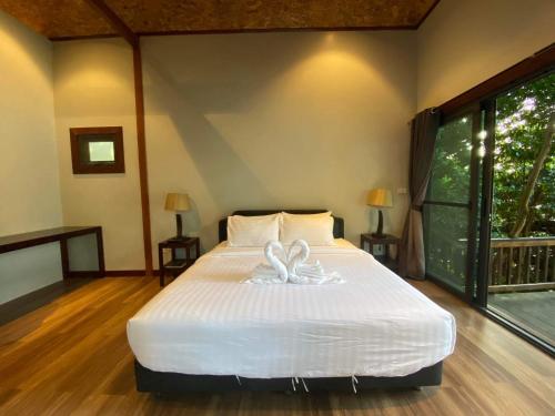 a bedroom with a bed with a towel on it at Cashewnut Cove in Ko Lipe