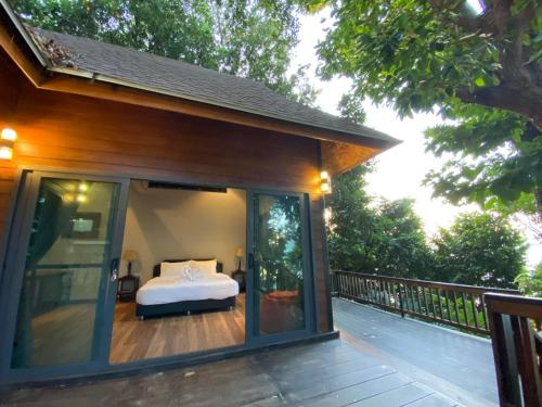 a bedroom on the deck of a house at Cashewnut Cove in Ko Lipe