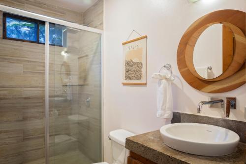 a bathroom with a shower and a toilet and a sink at Casa Papaya - Eco Casita Phase 1-1 in Iguana