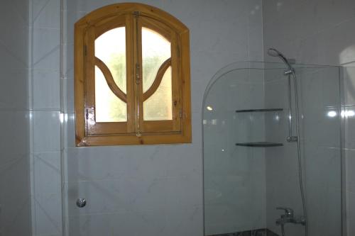 a bathroom with a window and a shower and a shower at Morning Start Apartments in Luxor