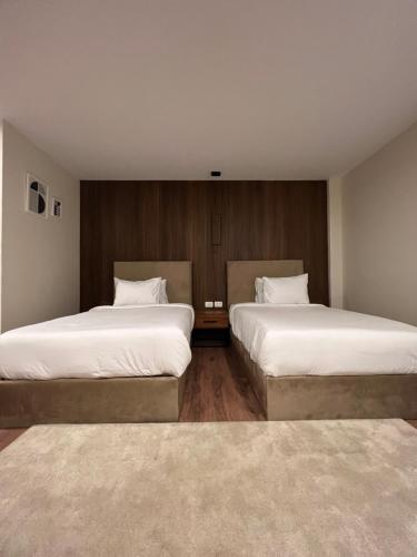 two beds in a hotel room with two at The Home Boutique Hotel Pyramids Inn in Cairo