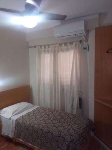 a bedroom with a bed and a ceiling fan at Hotel Alma di Mare in Mar del Plata