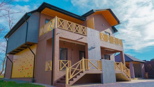 a building with a deck on the side of it at CHALET WOODS GUSAR in Qusar