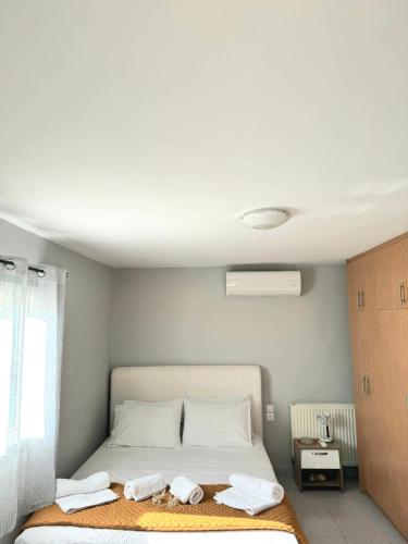a bedroom with a bed with towels on it at Lofos house in Karavadhos