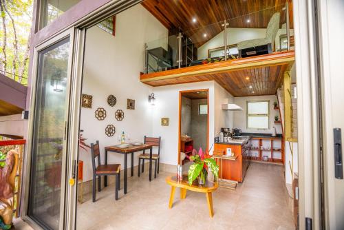 a kitchen and a living room with a balcony at Casitas Del Rio Riverfront Nature Lodge in Uvita