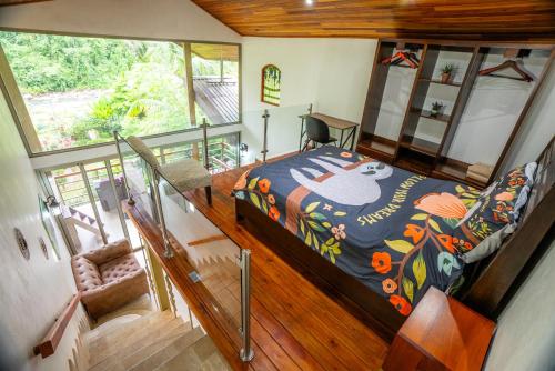 a bedroom with a bed with a colorful comforter at Casitas Del Rio Riverfront Nature Lodge in Uvita