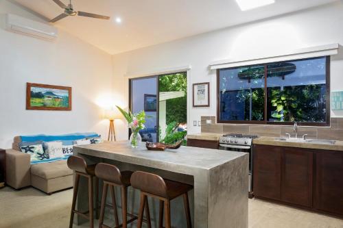 a kitchen with a table and chairs in a room at Eco Casita Phase III #2: Casa de Olas in Rivas