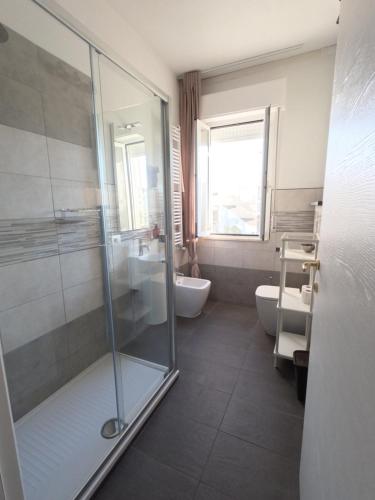 a bathroom with a shower and a toilet and a sink at Il Merlo in Pisa