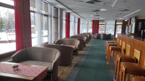 a row of chairs and tables in a restaurant at Hotel SOREA TITRIS in Tatranská Lomnica