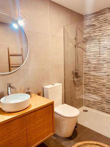 a bathroom with a toilet and a sink and a shower at Penagoda Beach House in Espinho