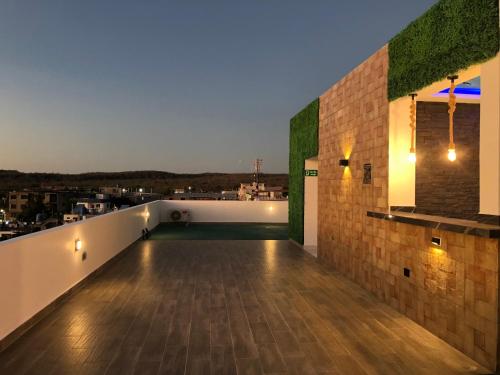 a balcony with a view of a city at night at Suites en el paraíso San Cristóbal Galápagos in Puerto Baquerizo Moreno