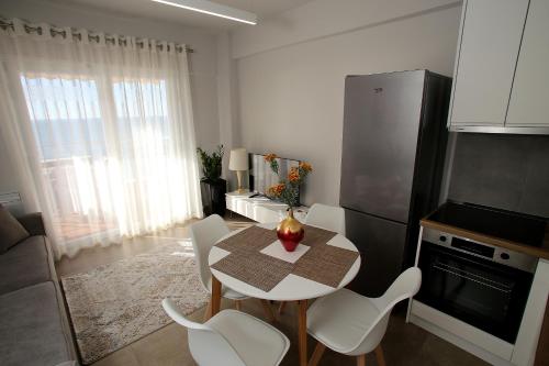 a kitchen with a table and chairs and a refrigerator at NOVA Sea View Apartments in Durrës