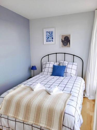 a bedroom with a bed with a blue pillow at Penthouse/ Rooftop Ocean view in Le Havre