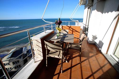 a balcony with a table and chairs on a boat at NOVA Sea View Apartments in Durrës