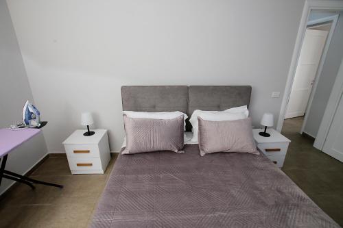 a bedroom with a large bed with two night stands at NOVA Sea View Apartments in Durrës