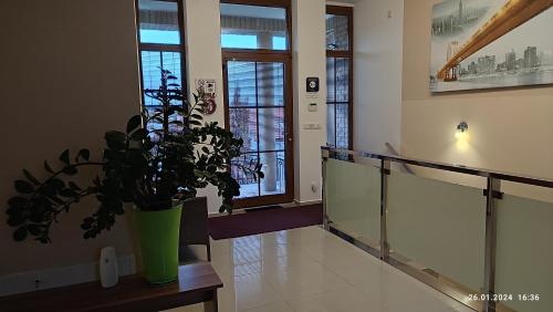 a hallway with a vase with a plant on a table at Villa Homestay Nad Helmrovkou in Prague
