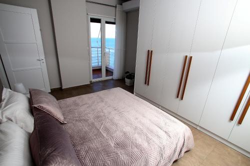 a bedroom with a bed and a couch in it at NOVA Sea View Apartments in Durrës