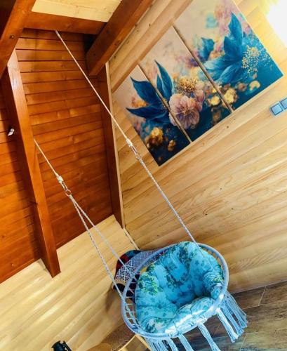 a swing in a room with a painting at Planinska kuća Mali Raj in Mrkonjić Grad