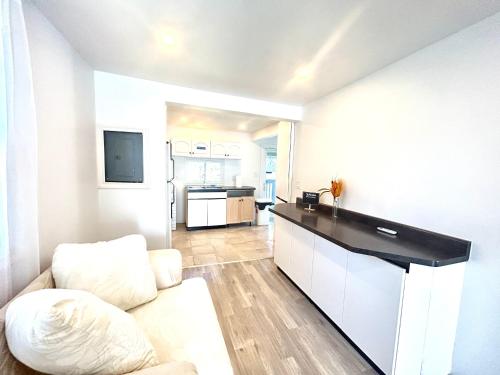 a living room with a couch and a kitchen at Aubin Paradise Housing in Windsor