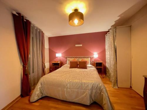 a bedroom with a large bed with two lamps at Le Rockastel in Le Caylar