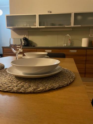 a table with three bowls and a wine glass on it at Apartmán Pistácia 2 priame centrum BB in Banská Bystrica