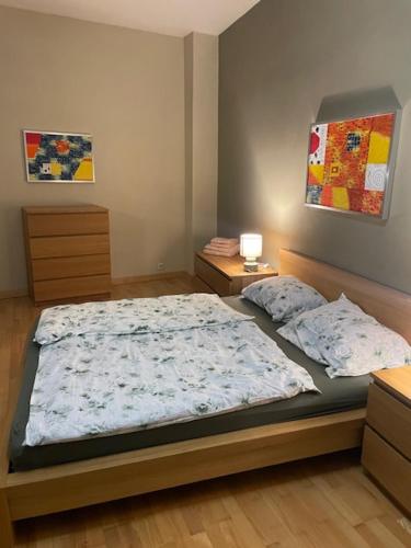 a bedroom with a bed and two night stands at Apartmán Pistácia 2 priame centrum BB in Banská Bystrica