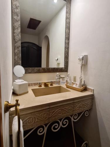 a bathroom with a large sink and a mirror at Hotel Casa Divina Oaxaca in Oaxaca City