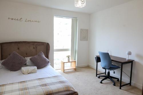 a bedroom with a bed and a desk and a chair at Centrally located 1BR Apt near Edg Cricket, University of Bham, Priory Hospital & Cannon Hill Park in Birmingham