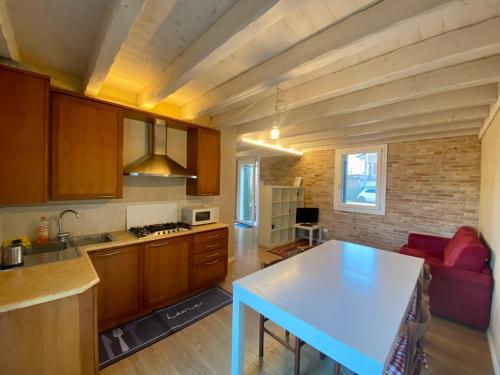 ミラーノにあるChez Albertoの白いテーブル付きのキッチンが備わる客室です。