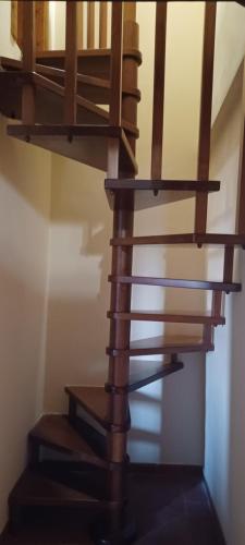 a wooden spiral staircase in a room at Poggio Giulia in Montaione