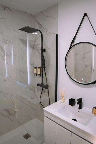 a bathroom with a shower with a sink and a mirror at Casa do Carriço in Peso da Régua