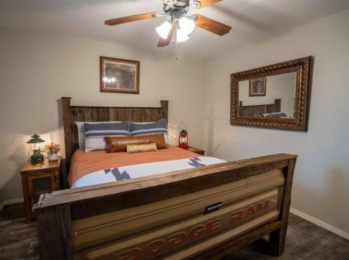 a bedroom with a bed with a ceiling fan and a mirror at The Judge in Warner 