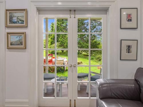 a living room with french doors leading to a patio at The Folly in Bilpin