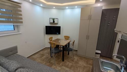 a living room with a table and a couch at Vila Plan Karaman greben in Raška