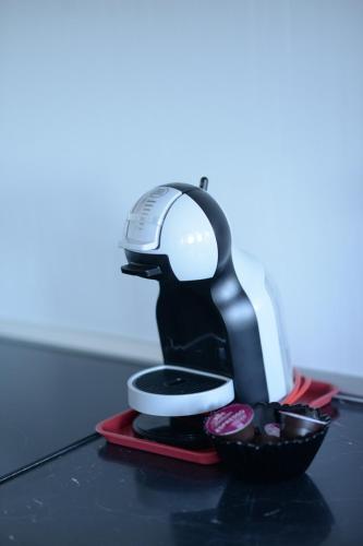 a mixer sitting on a table with a bowl of cupcakes at Irina Lux Apartment in Negotin