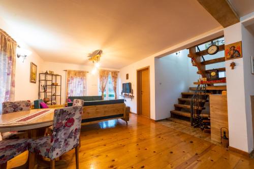 a dining room and living room with a table and chairs at Vila Kristina in Andrijevica