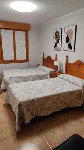 two beds in a room with two beds sidx sidx sidx sidx at Casa Jacobea in Grañón