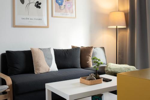 a living room with a couch and a table at Loomená Apartments - Free Garage in Košice