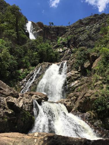a waterfall on the side of a mountain at Casa do Alecrim in São Roque de Minas