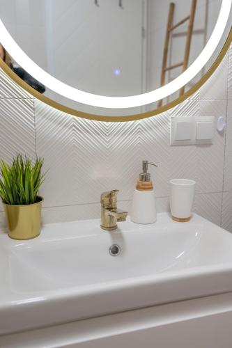 a bathroom with a sink and a mirror at Pod Kalwarią in Nowosiółki Dydyńskie