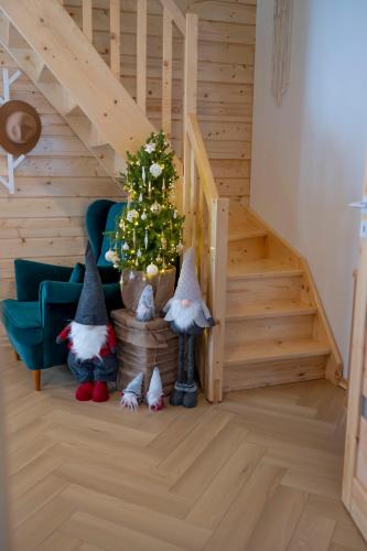 a living room with a christmas tree and a staircase at Pod Kalwarią in Nowosiółki Dydyńskie