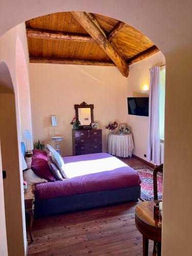 a bedroom with a large bed and a table at Panoramic villa with pool in Bolsena