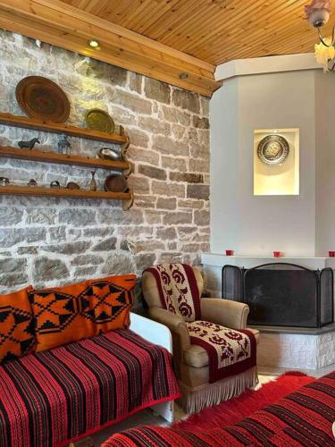 a living room with a couch and a fireplace at Chouliarades Tzoumerka in Chouliarades