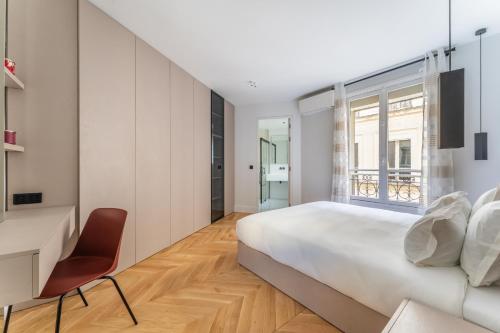 a bedroom with a bed and a desk and a window at Luxury Living in Trocadéro in Paris