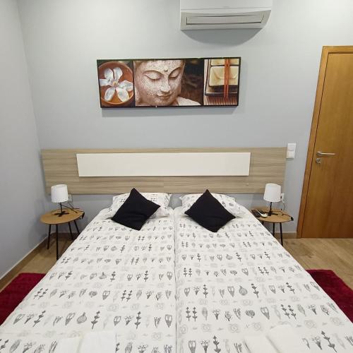 a bedroom with a bed with a white comforter at Good Vibes - Lagos Guesthouse in Lagos