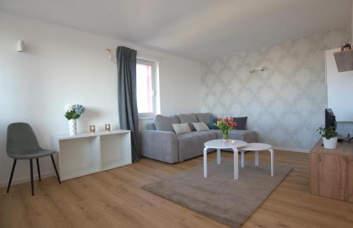 a living room with a couch and a table at Central Elite Vista-with parking in Ljubljana